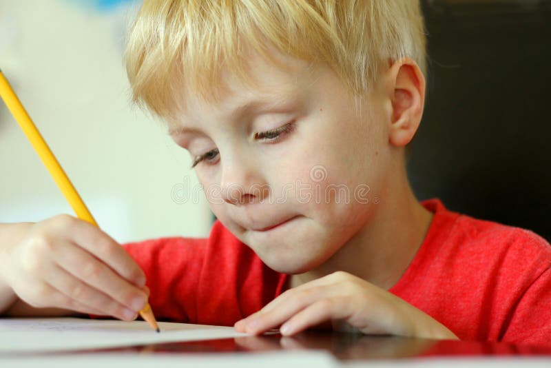 Young Child Drawing on Paper with Pencil royalty free stock image Young Child Drawing on Paper with Pencil royalty free stock image