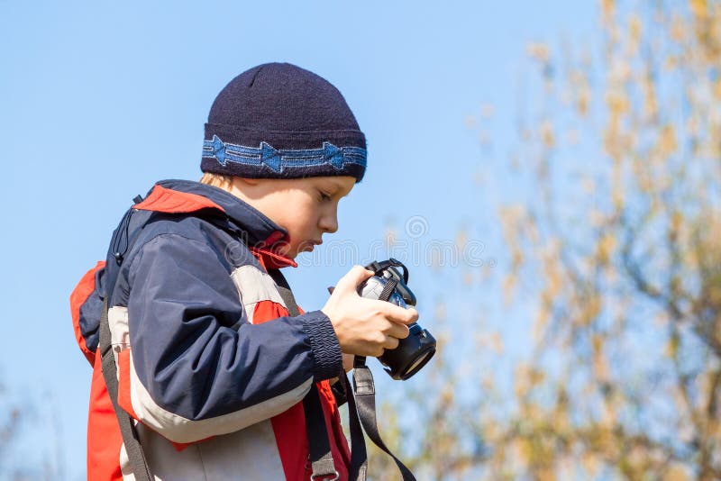 Young child holding and viewing photos on the camera