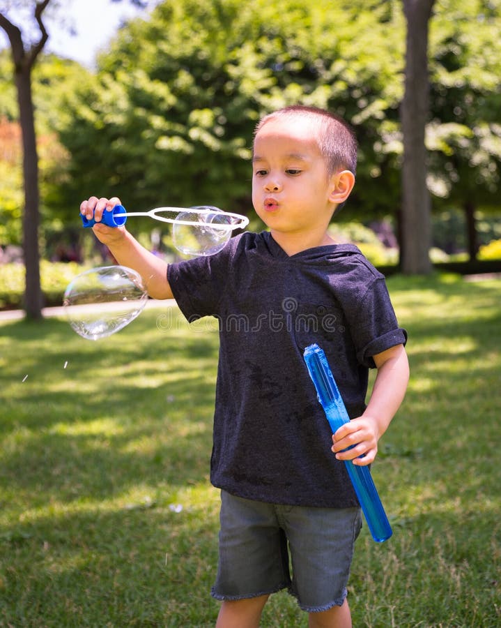 Young Child Playing with Bubbles Stock Photo Image of side, playing