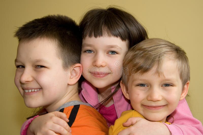 Young children hugging each other.