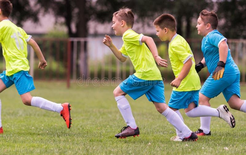 Young children players football match on soccer field stock image Young children players football match on soccer field stock image
