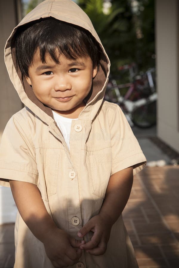 Young children wearing hood sweat with lovely face standing at h stock photos Young children wearing hood sweat with lovely face standing at h stock photos