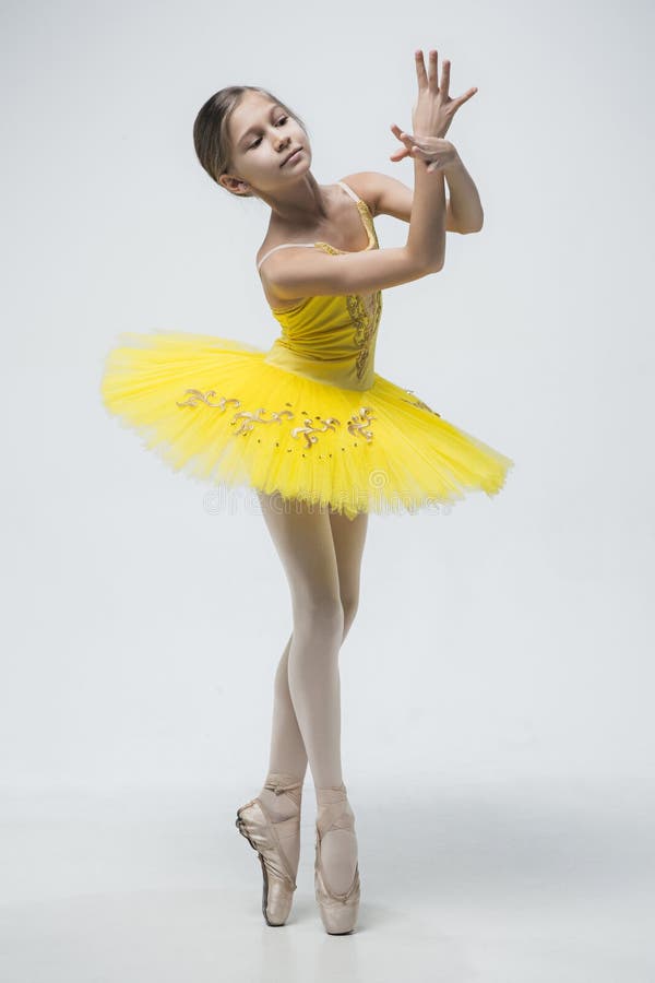 Young classical dancer on white background. stock photos