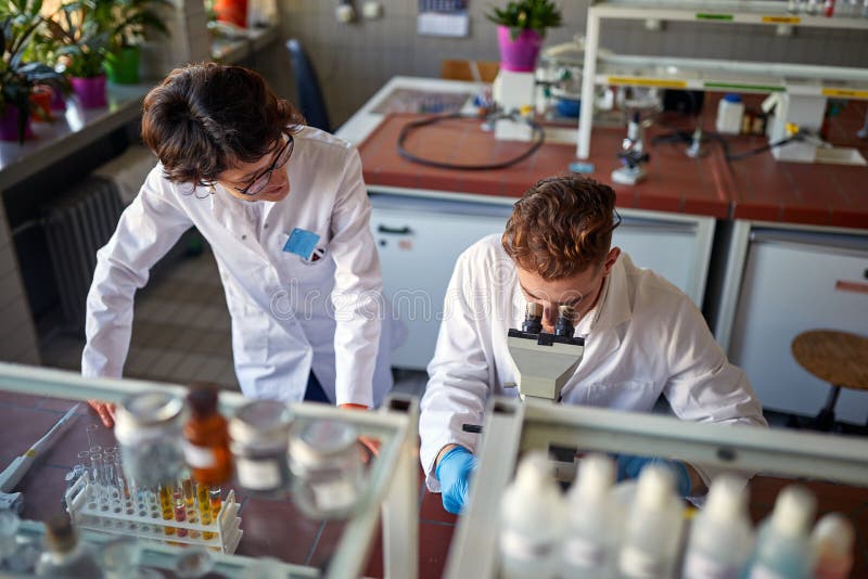 Young colleaugues work at the university laboratory. Science, chemistry, lab, people stock photo
