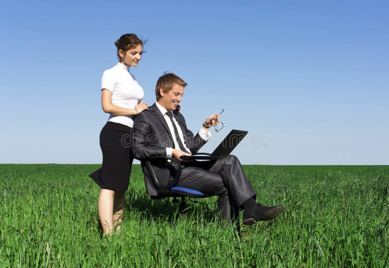 Young, confident businessmen working on laptop.