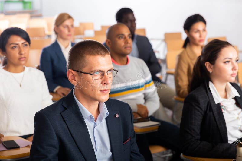 Focused man listening to lecture at conference royalty free stock photo