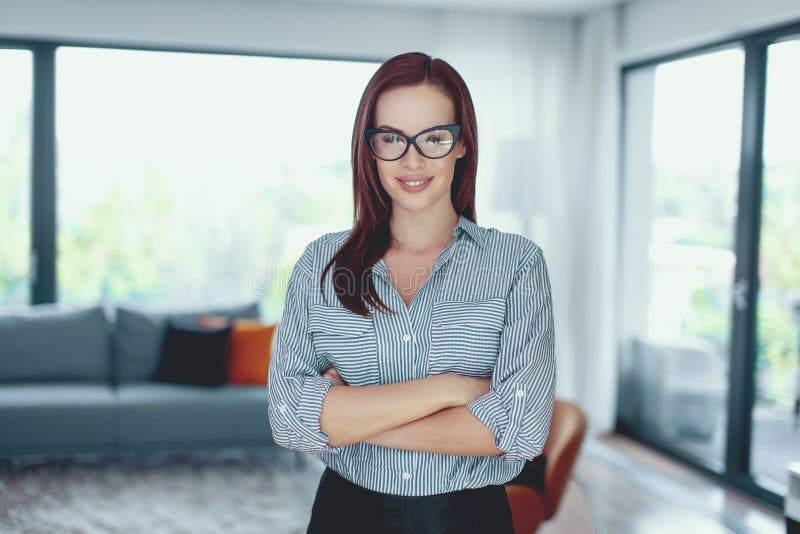Young confident modern businesswoman posing in living room royalty free stock photography Young confident modern businesswoman posing in living room royalty free stock photography