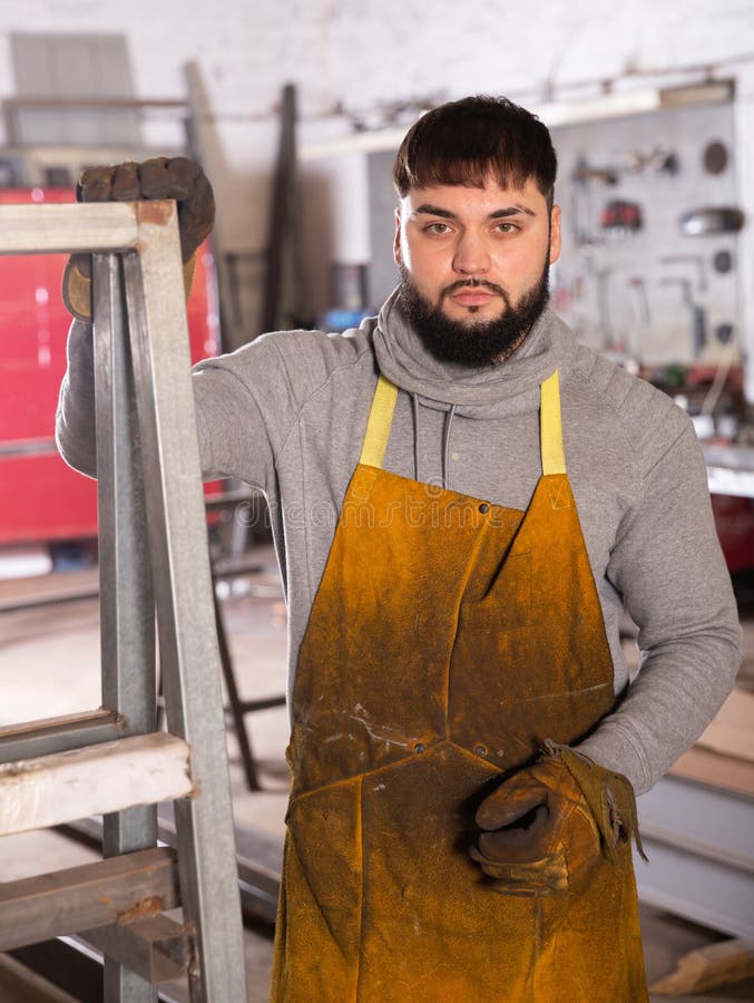 Blacksmith in metalworking workshop stock photos
