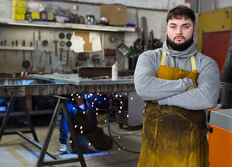 Blacksmith in metalworking workshop stock image