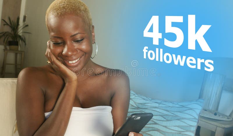 Young cool and happy black African American woman relaxed at home using internet mobile phone smiling cheerful networking getting stock photography Young cool and happy black African American woman relaxed at home using internet mobile phone smiling cheerful networking getting stock photography
