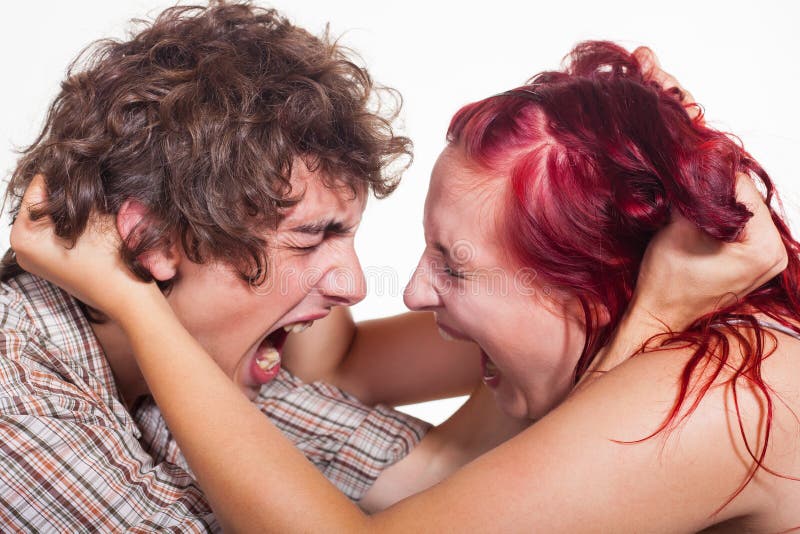 Close-up portrait of a pair of angry shouting against each other on a white background. Close-up portrait of a pair of angry shouting against each other on a white background