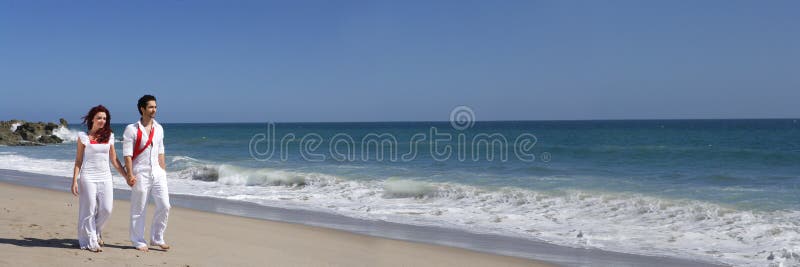 Young Couple at the beach walking