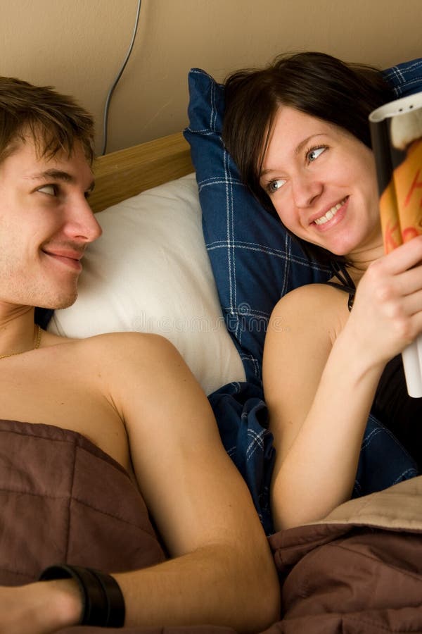 Young couple in bedroom stock image