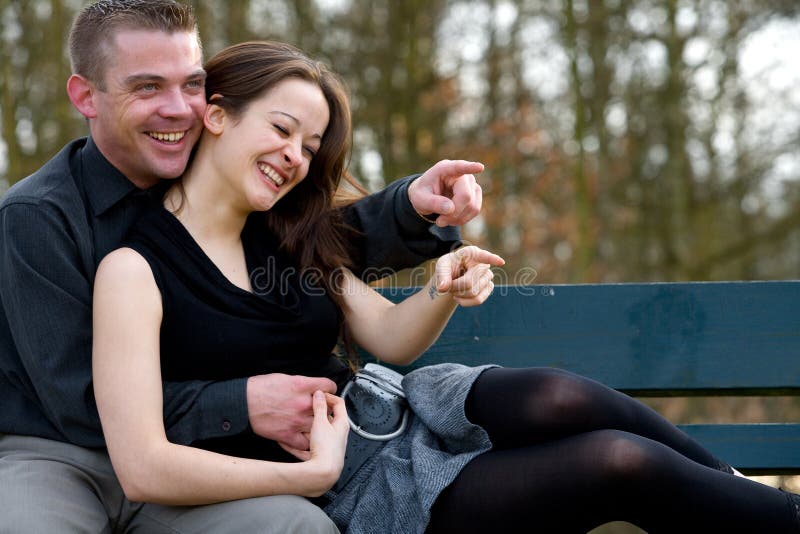 Young couple on a bench having fun