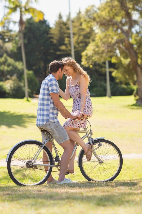 Young couple on a bike ride in the park