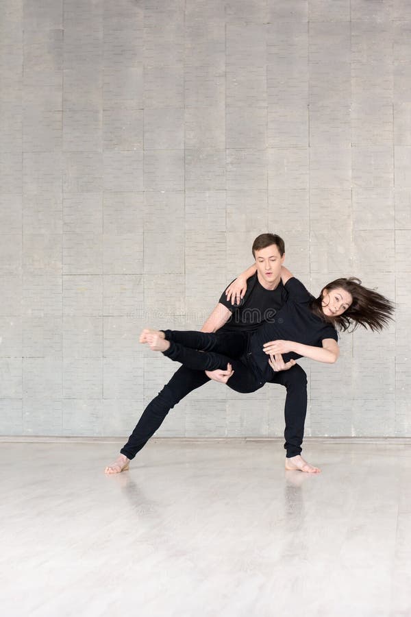 Young couple in black dancing. royalty free stock image Young couple in black dancing. royalty free stock image