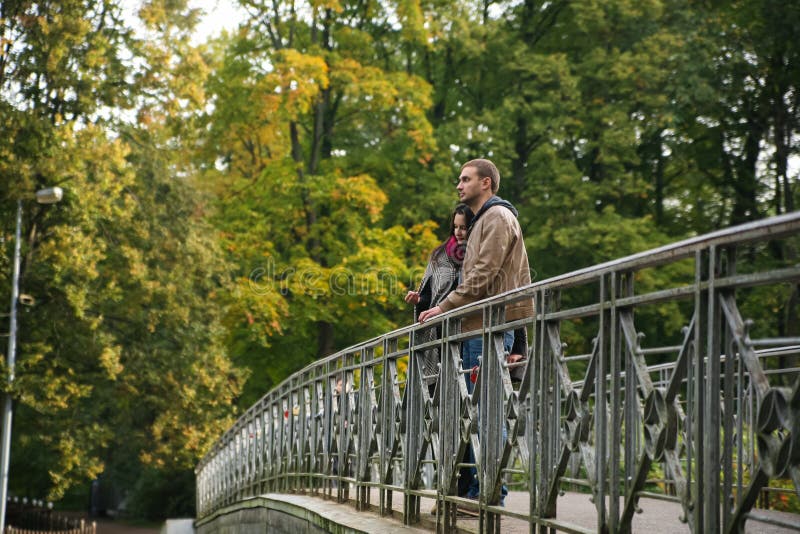 Young couple on a bridge in the fall royalty free stock photography