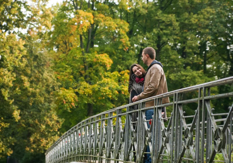Young couple on a bridge royalty free stock images