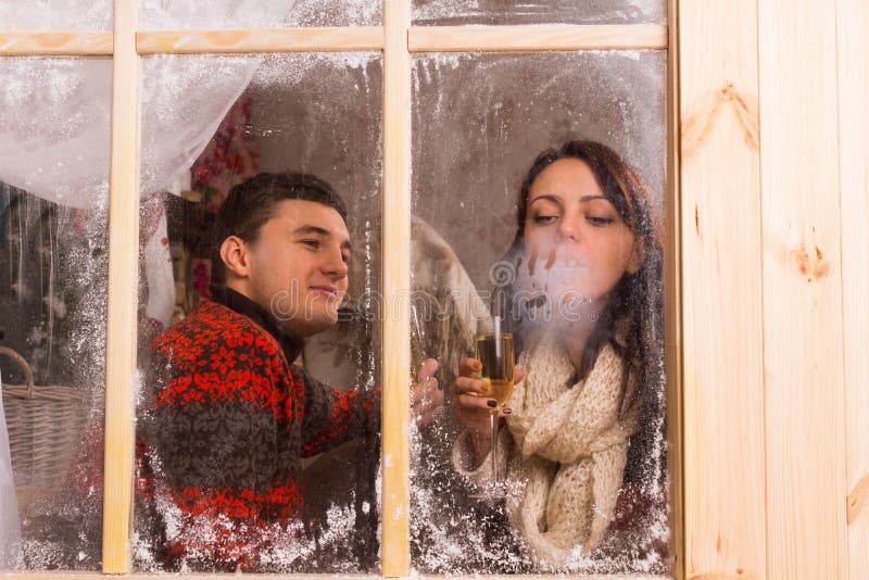 Young couple celebrating in a winter cabin