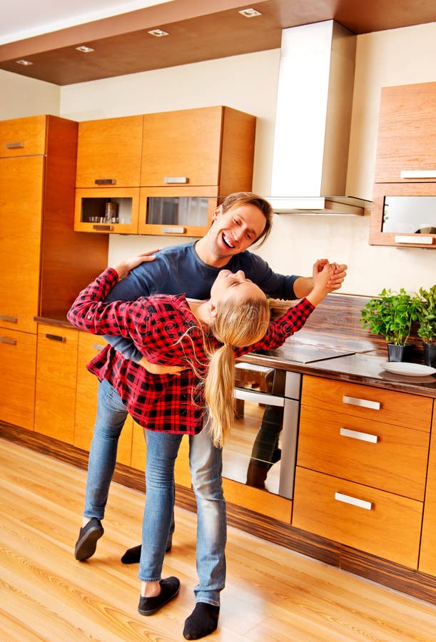 Young Couple Dancing and Having Fun in the Kitchen Stock Photo Image