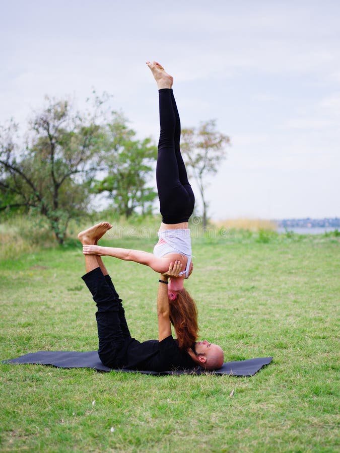 Young Couple Doing Acro Bird Yoga Pose. Healthy Lifestyle Modern ...