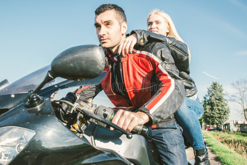 Young couple driving on a sport motorcycle royalty free stock photo Young couple driving on a sport motorcycle royalty free stock photo