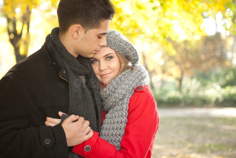 Romantic young couple embracing in autumn park