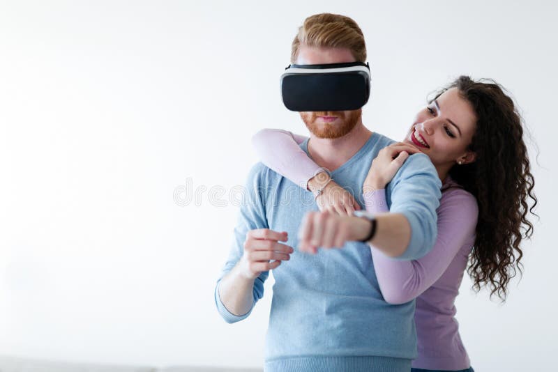 Young couple enjoy experience with virtual reality headset stock images Young couple enjoy experience with virtual reality headset stock images