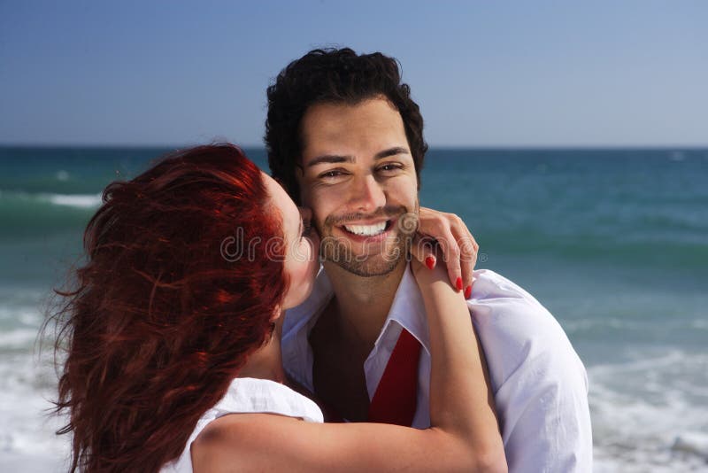 Young couple enjoying on the beach flirting