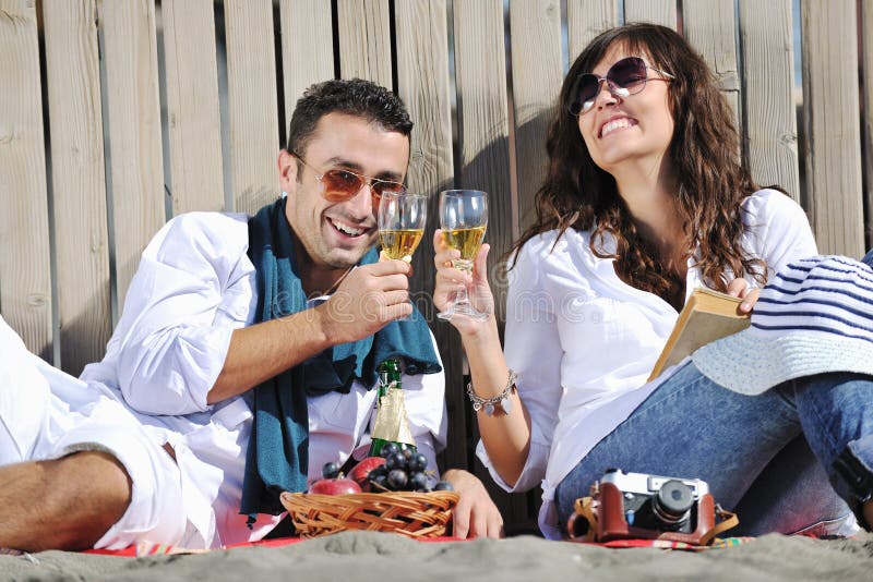 Young couple enjoying picnic on the beach