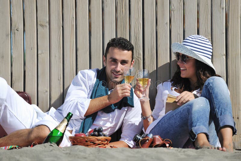 Young couple enjoying picnic on the beach