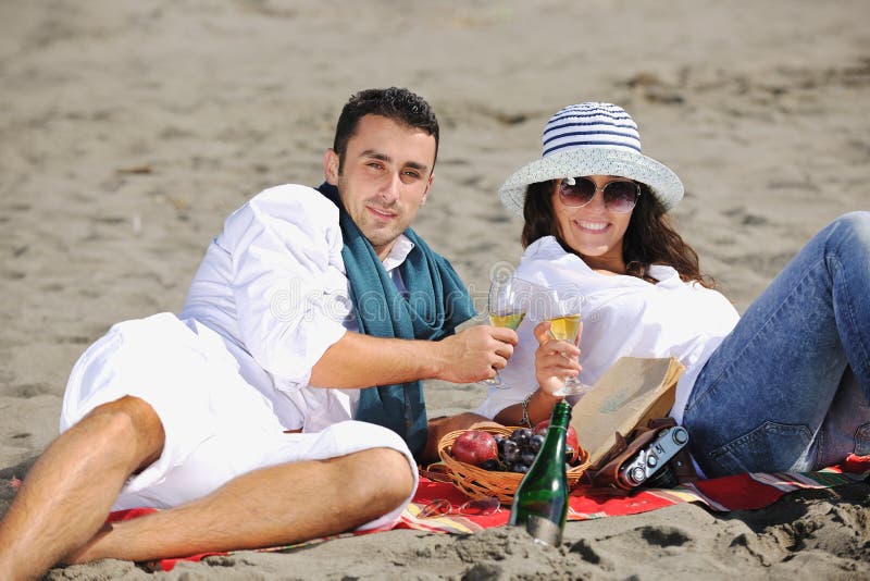 Young couple enjoying picnic on the beach