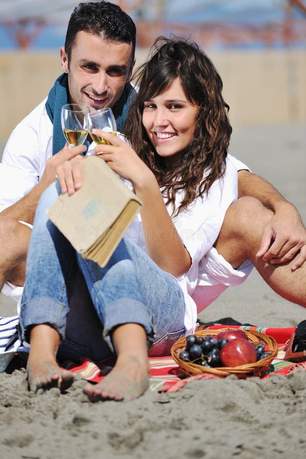 Young couple enjoying picnic on the beach