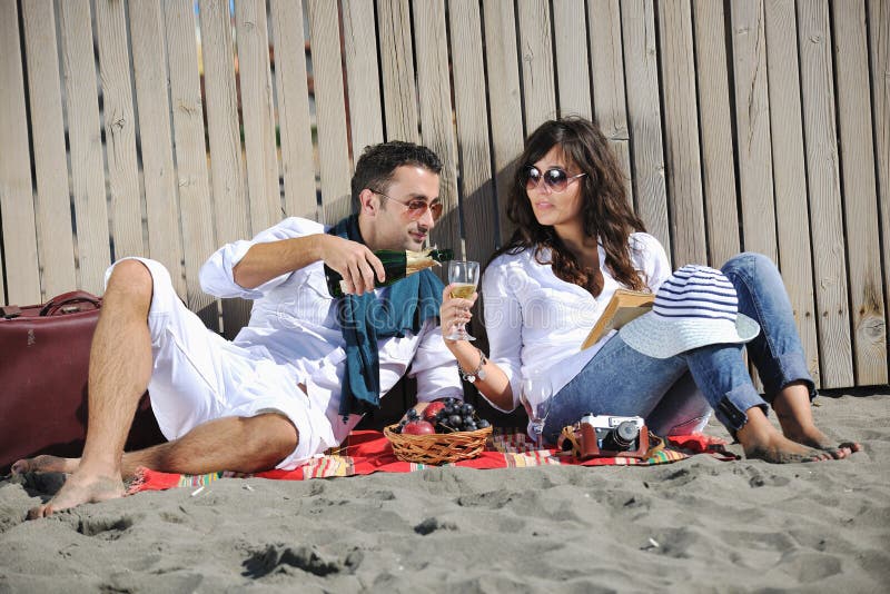 Young couple enjoying picnic on the beach