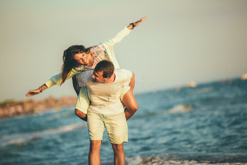 Young Man Giving Woman Piggyback Outdoors, Stock image