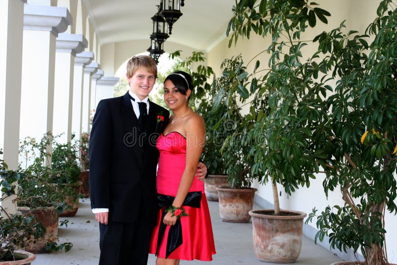 Young Couple in formal attire peeking out