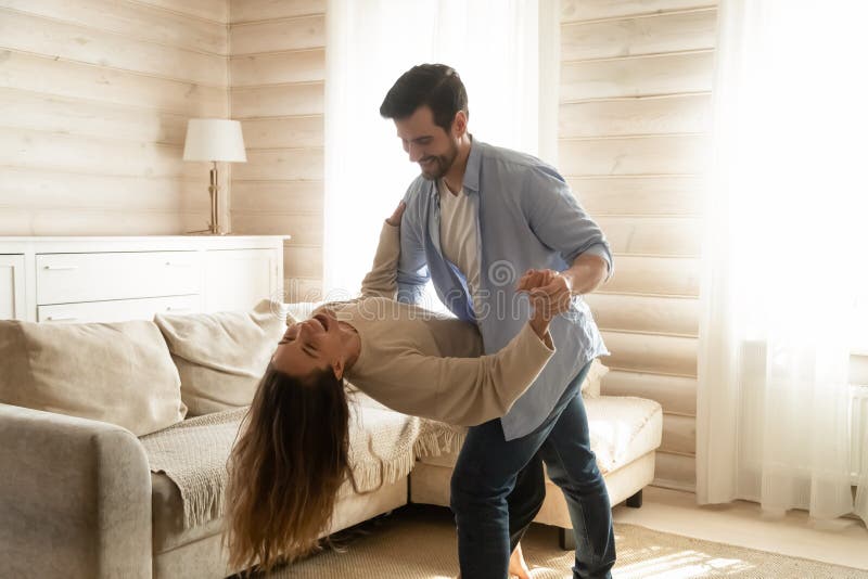 Young couple have fun dancing tango at home