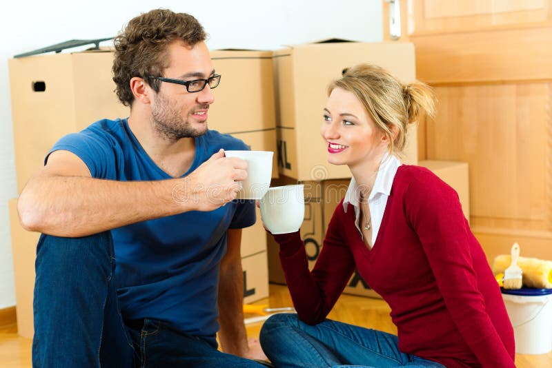 Young couple having break while moving in royalty free stock photo Young couple having break while moving in royalty free stock photo