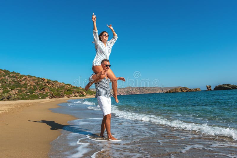 Young Couple Having Fun On The Beach Summer Vacations Concept Stock