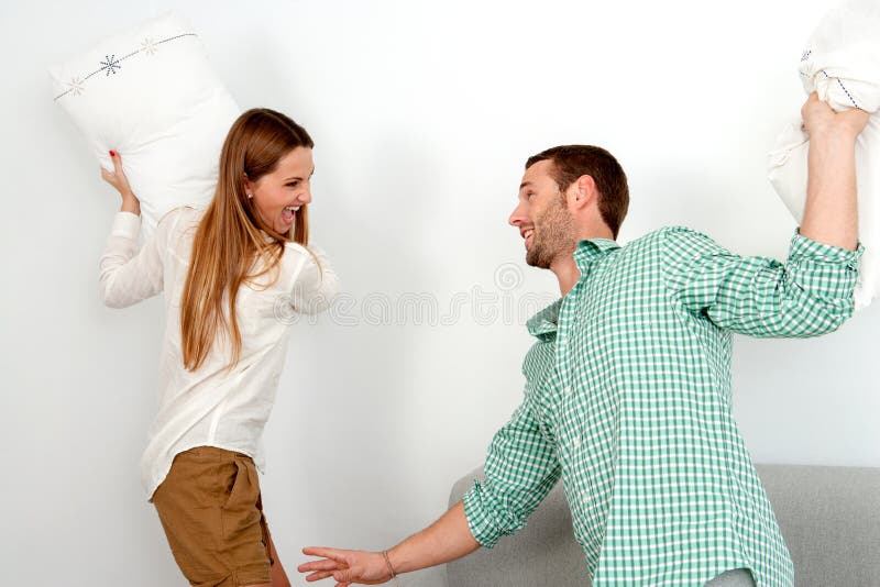 Young Couple Having Pillow Fight. Stock Image Image of beauty, people