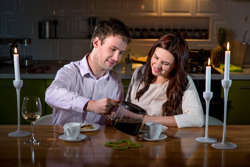 Young couple having romantic dinner on the dinner table at home stock image Young couple having romantic dinner on the dinner table at home stock image