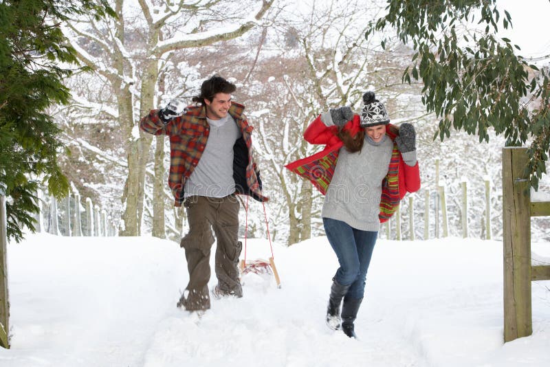 Young couple having snowball fight