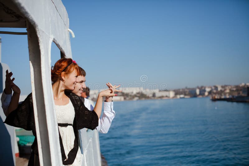 Young couple holding hands on the tour boat