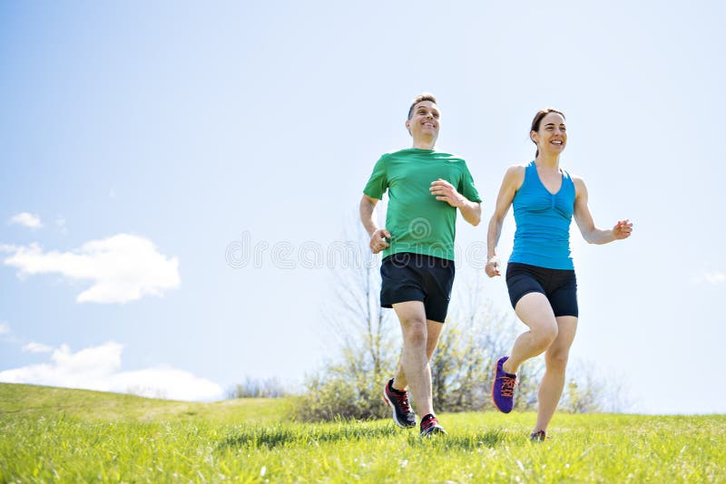 Young couple jogging in park at morning. Health and fitness. royalty free stock photos Young couple jogging in park at morning. Health and fitness. royalty free stock photos
