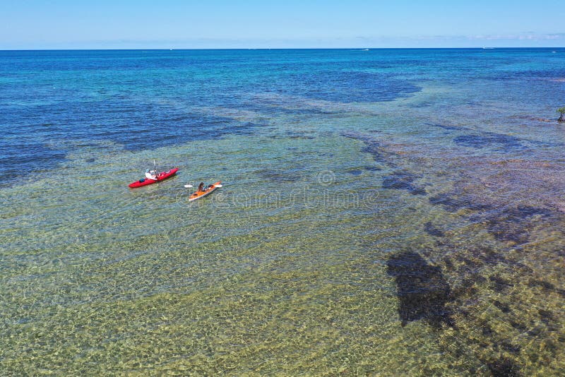 Young couple kayaking on Bear Cut off Key Biscayne, Florida on sunny afternoon.