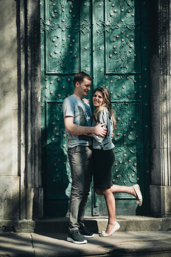 Young couple kisses near the vintage green door. royalty free stock photography Young couple kisses near the vintage green door. royalty free stock photography