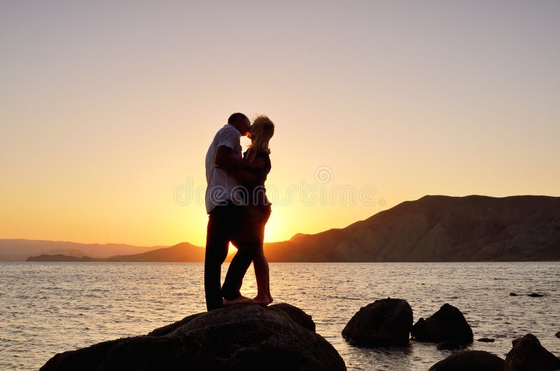 Young couple kissing on the beach royalty free stock photo Young couple kissing on the beach royalty free stock photo