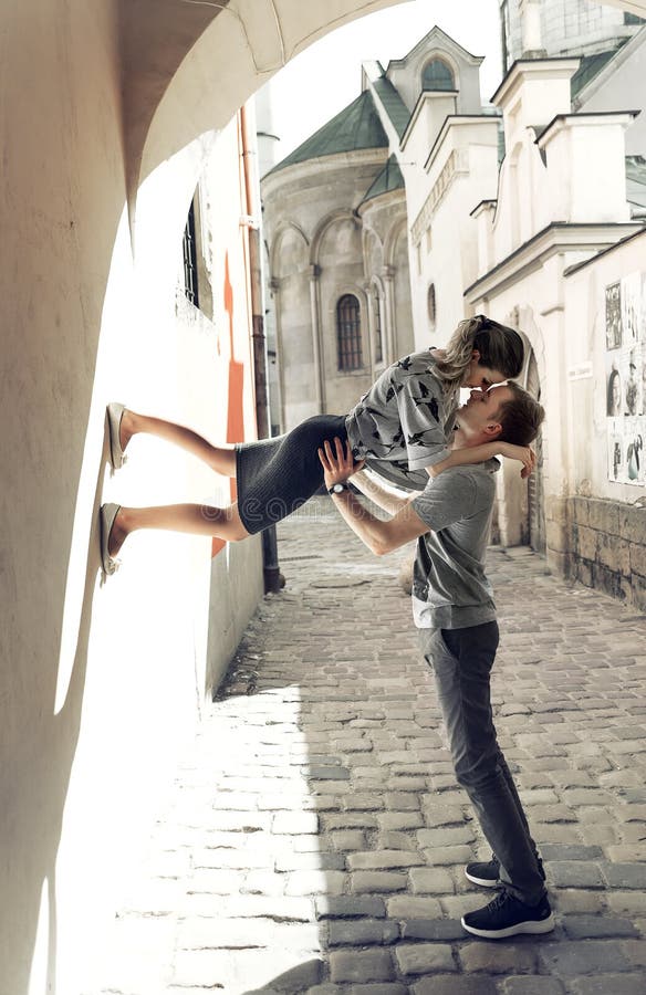 Young couple in love, kissing in the old part of town royalty free stock photo Young couple in love, kissing in the old part of town royalty free stock photo