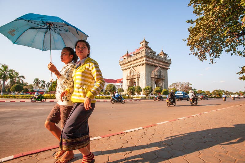 Young couple Laos girls in lao traditional clothing walking past