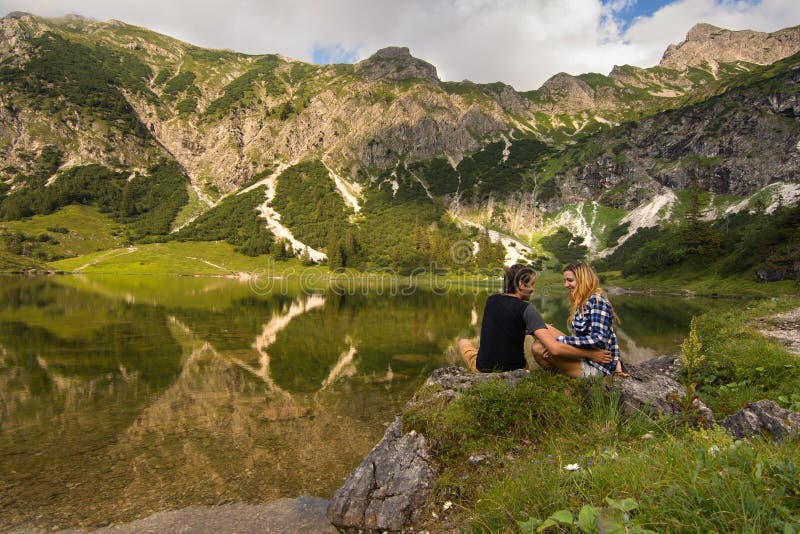 Young Couple Laughing and Having Fun in Front of a Mountain Lake ...